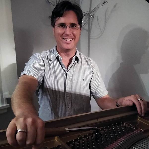 Hoyt tuning a piano.